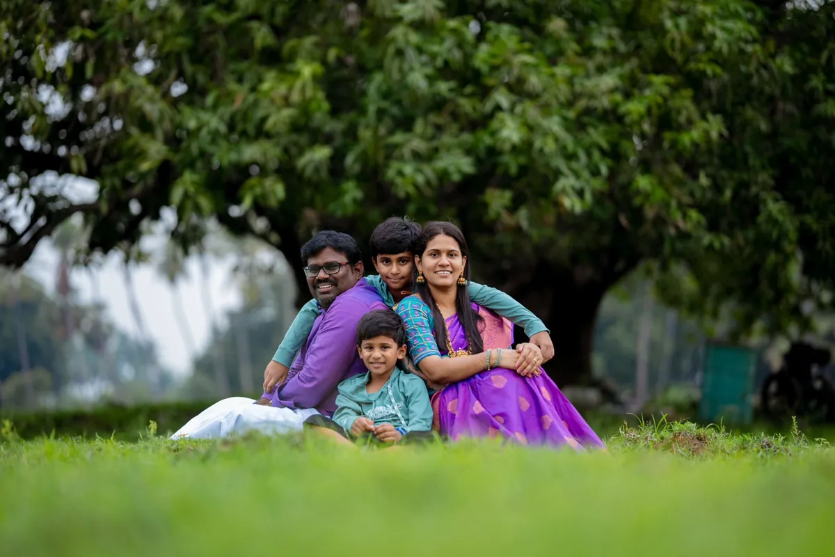 Family seated together on the grass