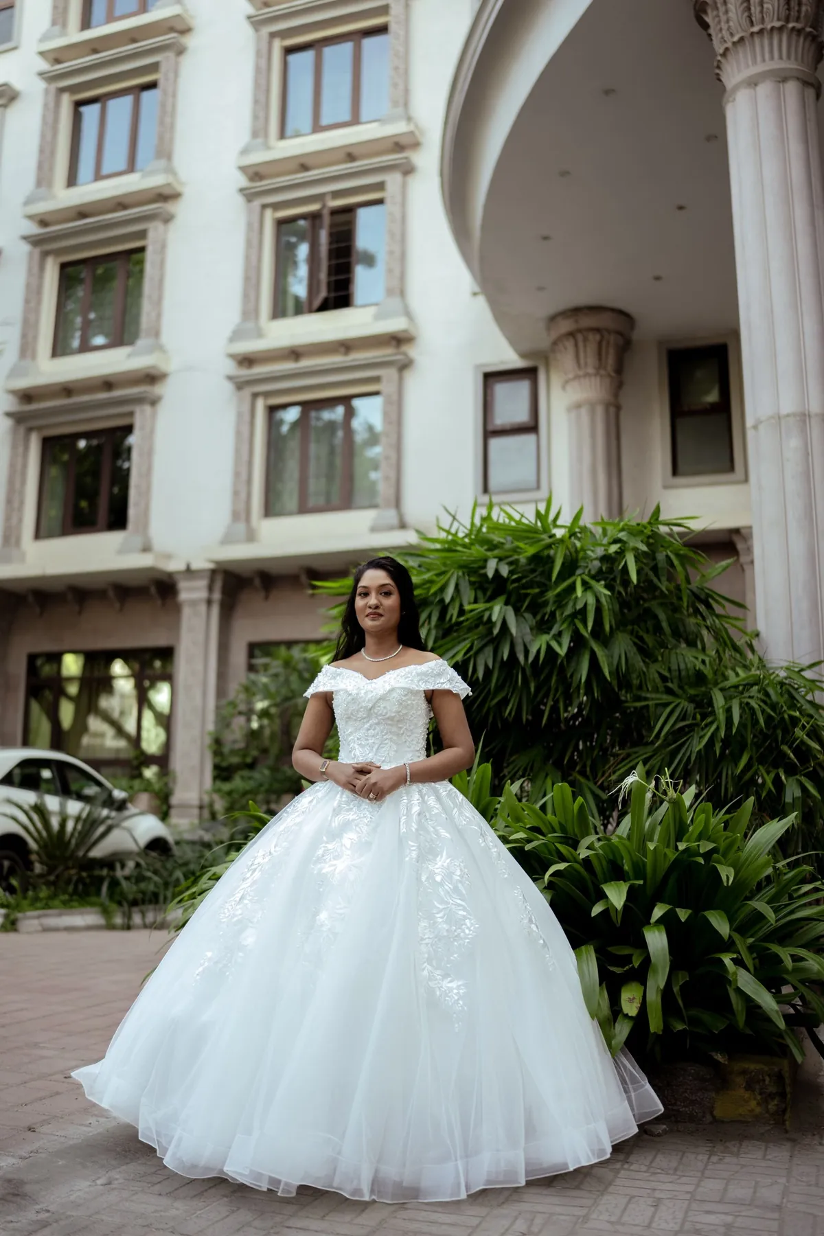Bride standing beneath a stone archway