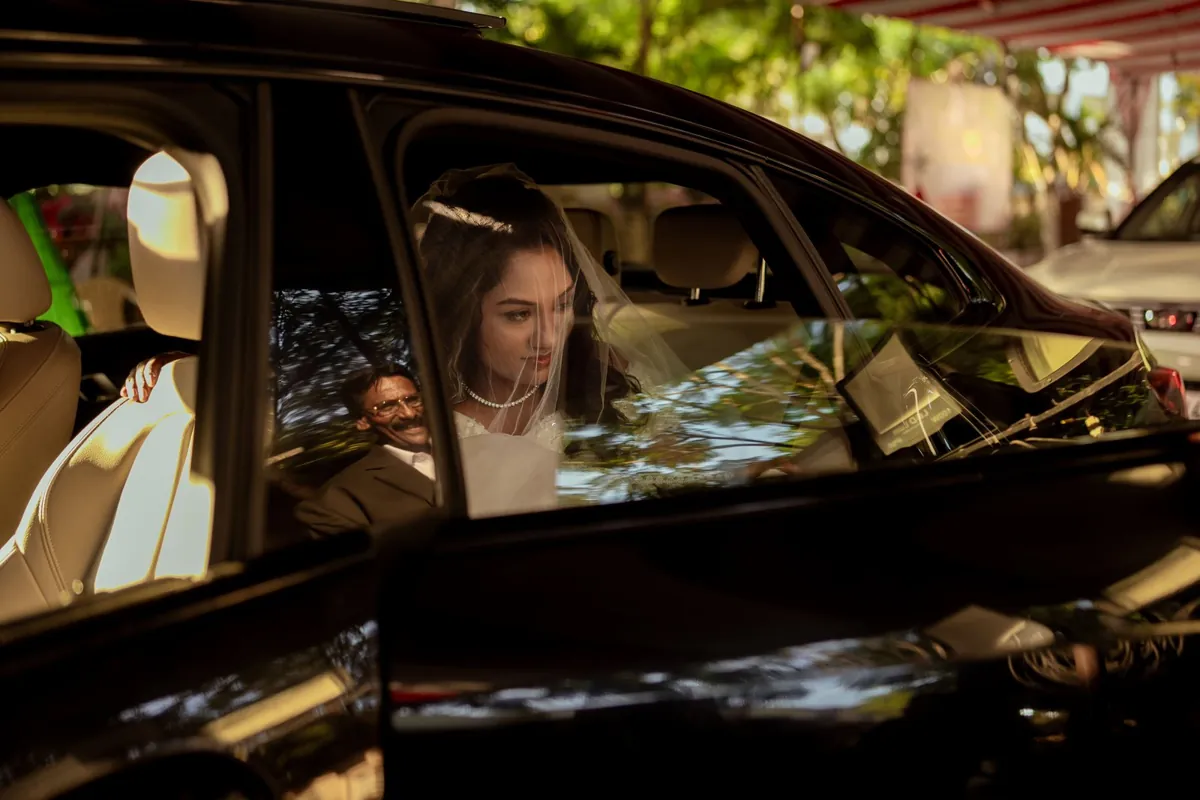 Bride seated inside a wedding car