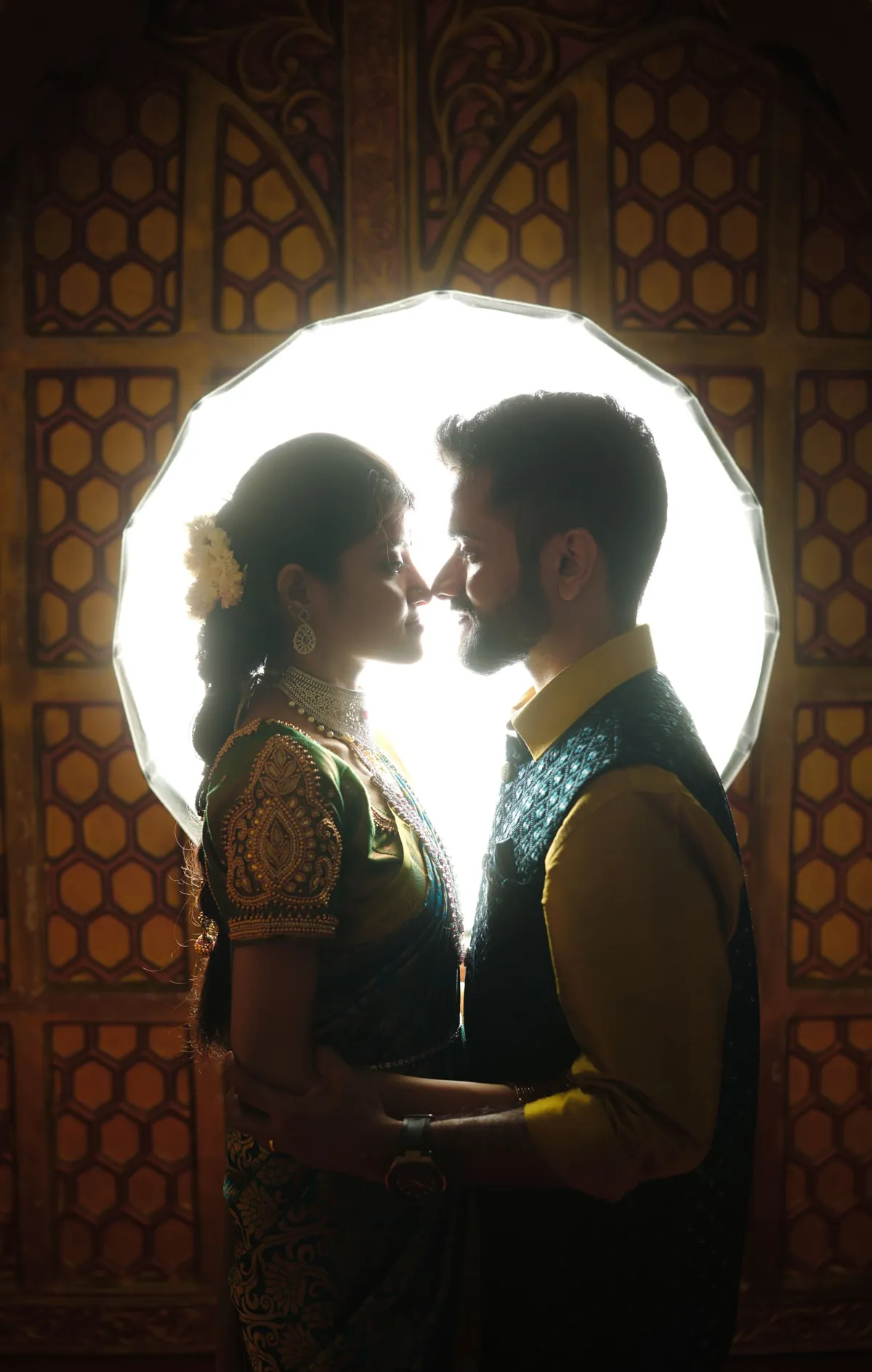 Couple silhouetted inside a decorative arch