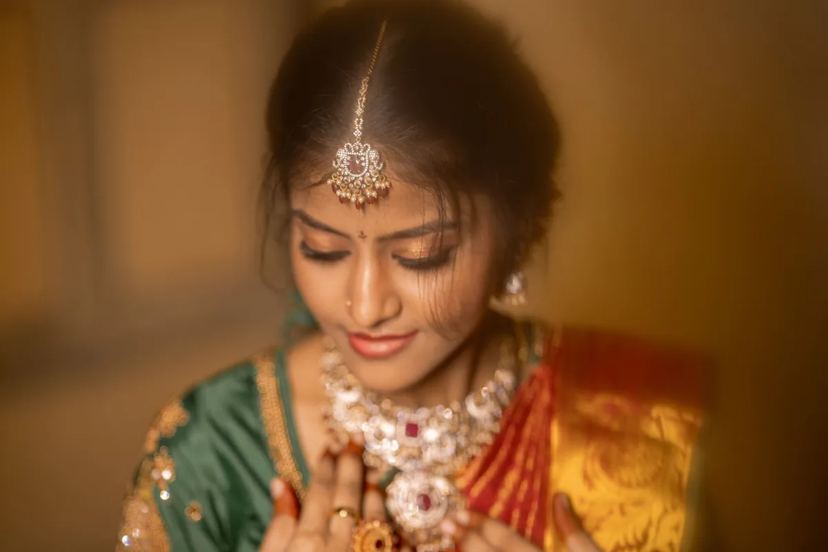 Bridal portrait with gold jewellery and green silk
